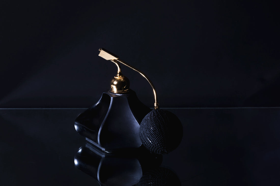 Luxury fragrance bottle in a dark editorial setting
